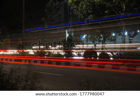               Light traffic trails in the city town. Speed motion blur.                