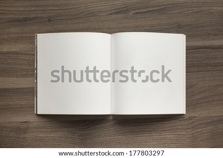 Photo blank. Open square format brochure on a wooden table