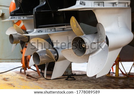 Motor propellers for motor yachts and boats close-up. The motors are mounted at the stern of the motor boat. Repair a boat in a dry dock. Royalty-Free Stock Photo #1778089589