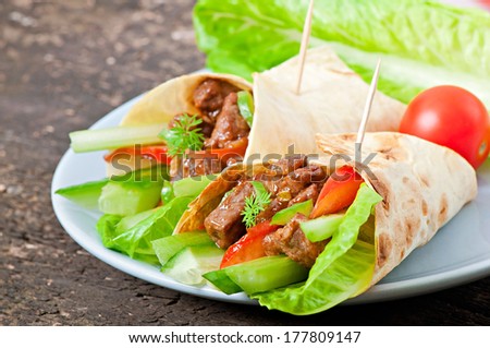 Tortilla wraps with meat and fresh vegetables