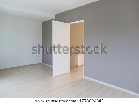 Open door in the white room of new house Royalty-Free Stock Photo #1778096345