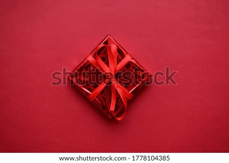 Red gift boxes on red background. Gift boxes with ribbons.