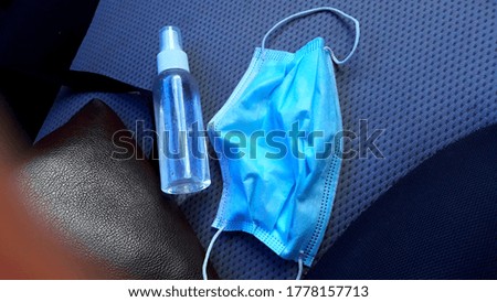Covid 19, Protective Equipment, Still in the Epidemic, Everyone Must Have, Masks, Alcohol Gel, Photo Alcohol Bottles, Masks, Put on Colored Car Seats Gray as the background and the right edge of the p