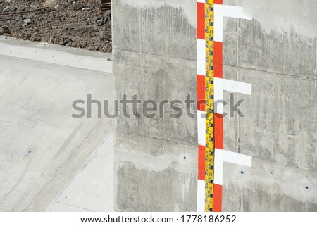 Water level indicator on concrete wall at new watergate. Concept of level indicator, water level, sign.