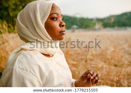Portrait Of Thoughtful African American Woman Outdoor On Beach.