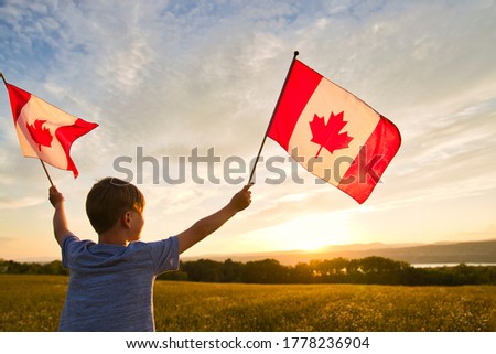 Adorable cute Caucasian boy holding Canadian flag on the father shoulder Royalty-Free Stock Photo #1778236904