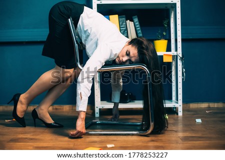 Tired businesswoman sleeping on office chair. Young exhausted pretty girl resting in unnatural pose, falling asleep on the go. Tinted image.