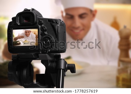 Food photography. Shooting of chef with dish, focus on camera