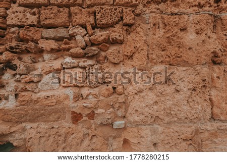 Stone wall texture/background,historical old ancient stone,preserved to our time, stones are laid evenly, solid construction has been standing for many centuries,ancient buildings,buildings and ruins