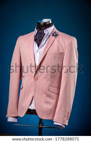 Male luxurious classic suit checkered pink jacket on dummy or mannequin on blue background Royalty-Free Stock Photo #1778288075