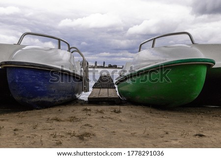 colorful boats of different sizes on the shore of the city reservoir. no people. High quality photo