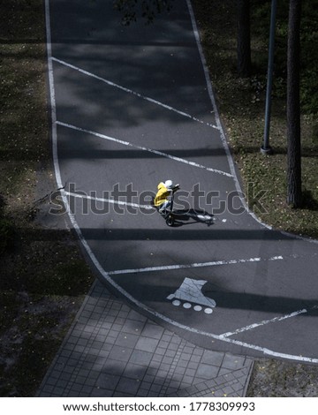 A photo of a child on a scooter shot in Latvia