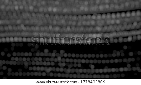 The abstract texture of many small white bokeh on a black background...by art effect.