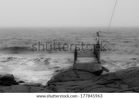 A picture of a small bathing pier in an atmospheric setting.