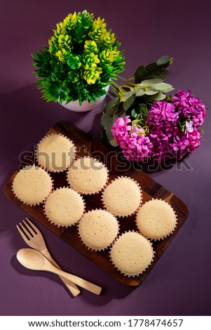 Ancient egg cakes in paper cup with purple background - stock photo