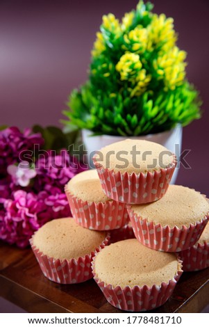 Ancient egg cakes in paper cup with purple background - stock photo