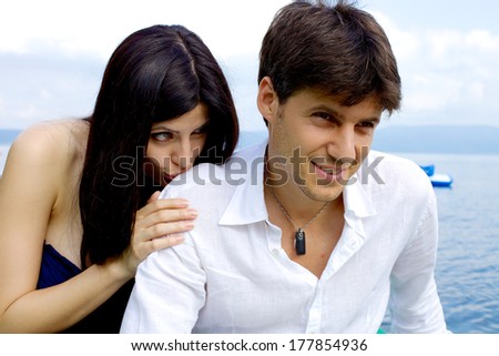 Man smiling while girlfriend asks to forgive her
