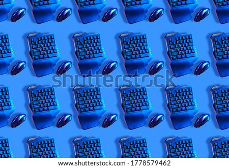 Seamless pattern with games keyboard and mouse on blue background. Concept of games.