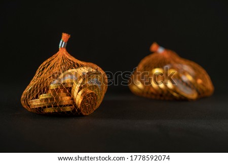 Chocolates in the shape of euro coins  in a net with a depth of field view. Royalty-Free Stock Photo #1778592074