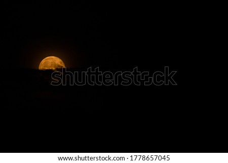 Full moon orange clouds dark night