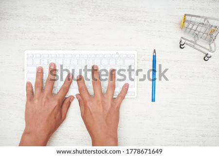 Background of desktop and tired man who is typing while sitting at work