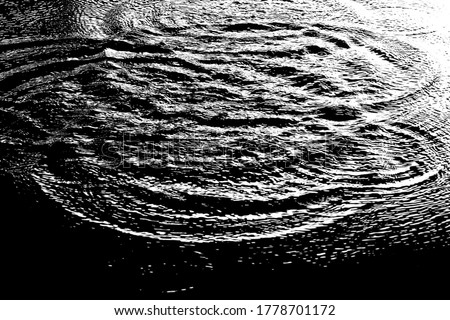 Black and white picture of water waves in the river, sea or ocean in the dark. Image of water waves with high contrast.