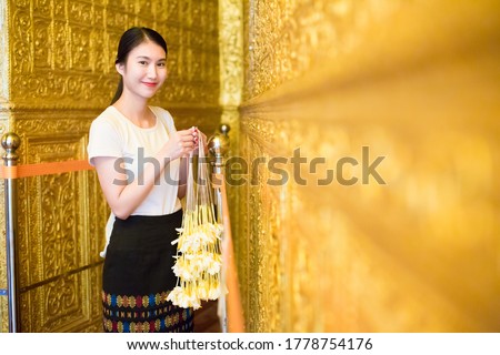 Portrait of Beautiful women with garland at Inside of  Pagoda in yangon Myanmar.