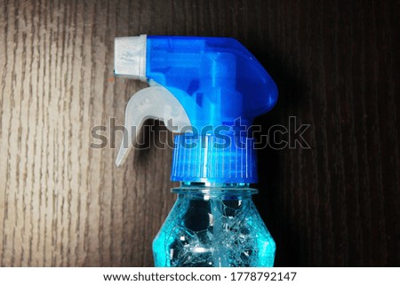 Alcohol based Hand sanitizer spray on wooden floor background 