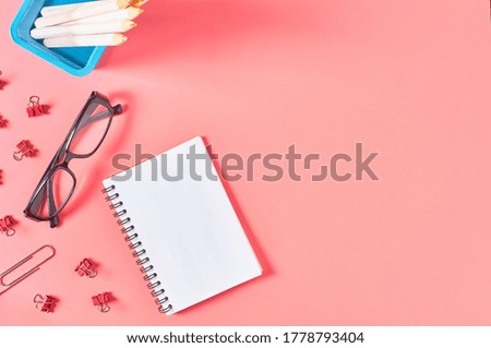Workplace with stationery accessories on pink countertop. Business or back to school concept. Secretaries workspace. Top view. Flat lay. Copy space