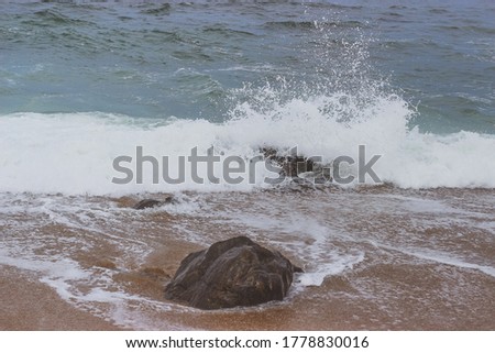waves breaking on stones shore, storm