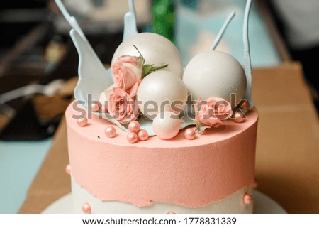 Close up beautiful cake with sweet white globes and pink roses flowers