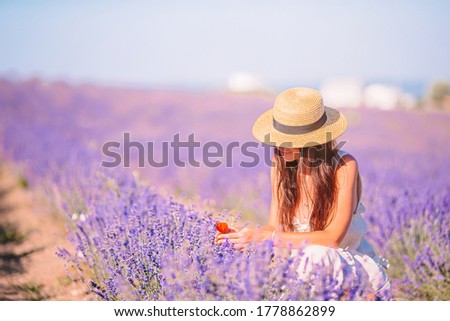 Beautiful young woman on purple flower lavender field