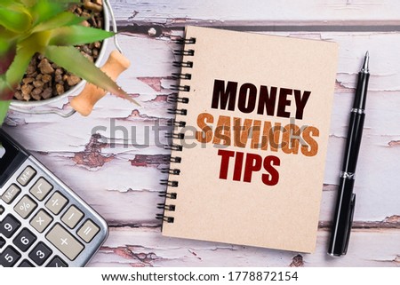 Money Savings Tips, text on small notepad with pen and calculator