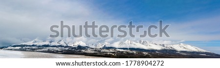 Tatra Mountains in Slovakia. Panorama of the mountain range. Winter in the mountains in nature. Blue and white colors. The tops of the mountains are covered with snow. Far from civilization Royalty-Free Stock Photo #1778904272