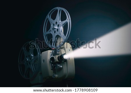  old film projector with stream of light