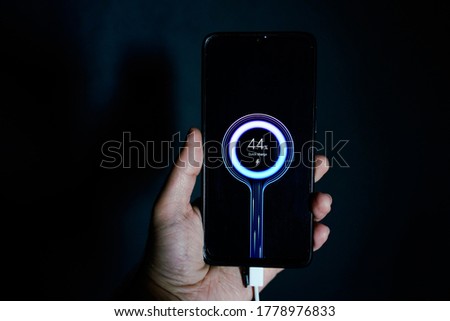 holding charging smartphone quick charge fast charge