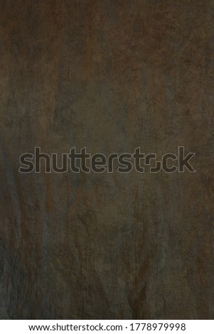 The texture of the popular fabric art background for portrait photography is green hue. Photo studio.