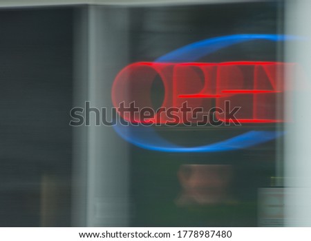Neon Open sign in red and blue with motion blur