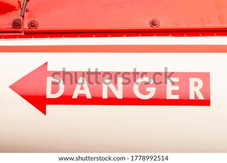 The arrow indicates danger On the shiny metal surface.