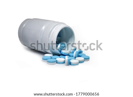 Pills spilling out of pill bottle. Assorted pharmaceutical medicine pills, tablets on white background