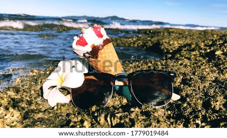 Ice cream glasses sea water beach.