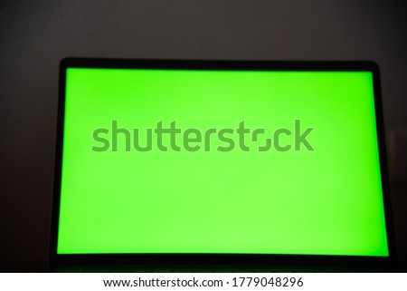 Close up laptop with green screen in background concept.