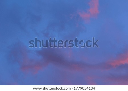 Delicate feathery pink clouds against a blue sky at sunset
