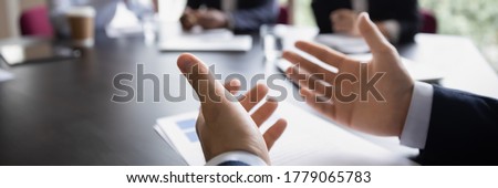 Businessman project leader gesticulate hands while talking during formal group meeting, close up. Convincing speech of speaker. Negotiations concept. Horizontal photo banner for website header design Royalty-Free Stock Photo #1779065783