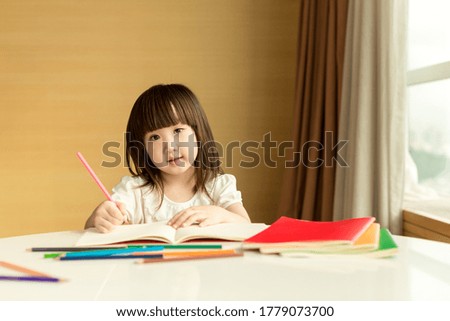 Little girl drawing picture at home