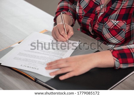 Woman hands signing a contract 