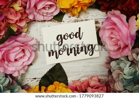 Good Morning Card with colorful flowers border frame on wooden background