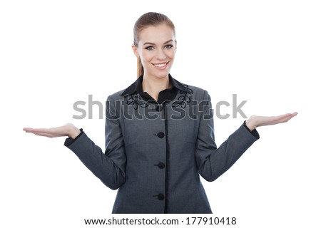 Woman with both her empty palms extended sideways presenting copy-space. Quizzical expression as she indicates that there is a choice or alternative, with copy space for the placement of your products