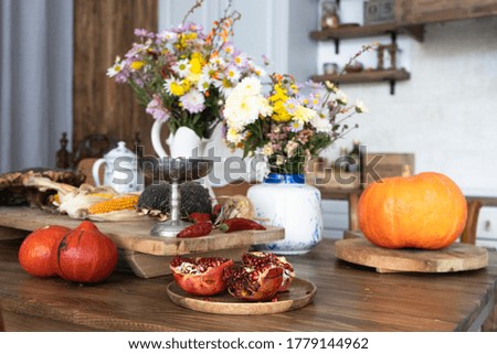 Autumn interior and still life. Pumpkins, apples, zucchini, autumn leaves and flowers. Background. Postcard. Flat lay.