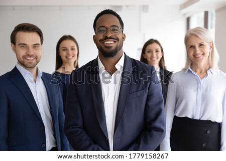 Diverse professionals bank employees company staff members in formal wear, 5 businesspeople lead by African ethnicity leader posing standing together in office. Young aged specialists portrait concept